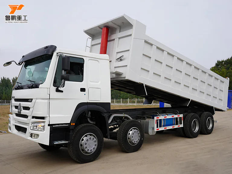 White SINOTRUK HOWO 430 8x4 dump truck with its cargo body raised